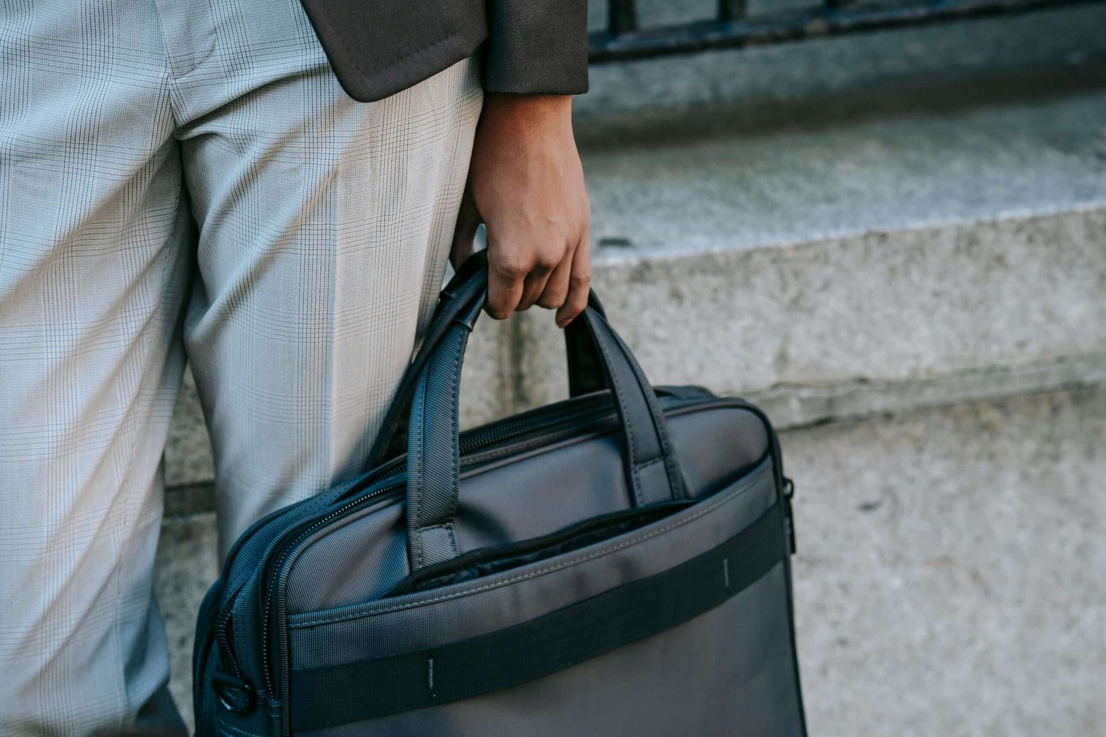 Close-up of a business professional holding a sleek briefcase, highlighting mobility and style.